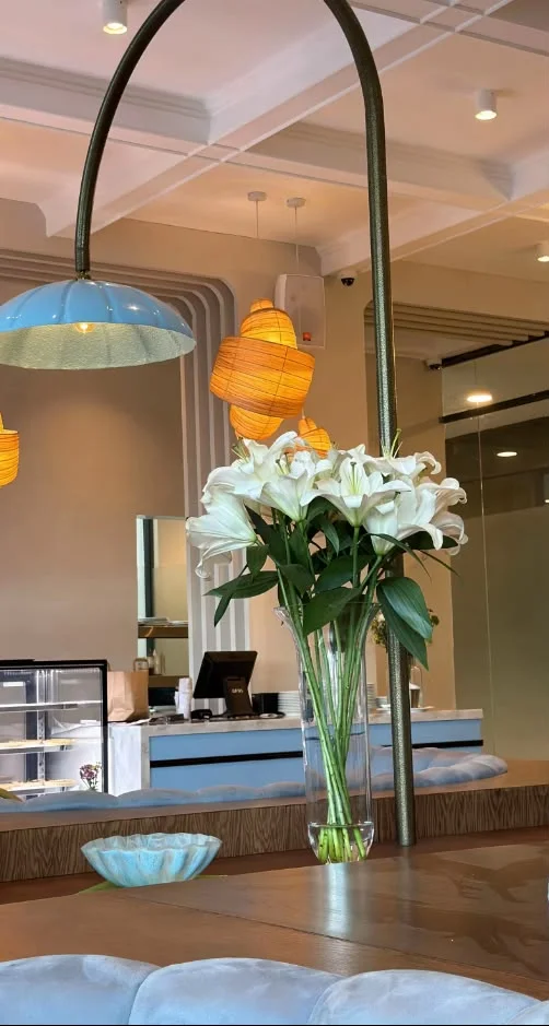 Fresh lilies resting on the Maison counter