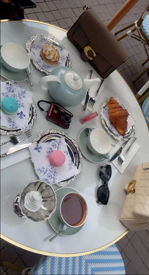 A Maison breakfast table seen from above, croissants and coffee